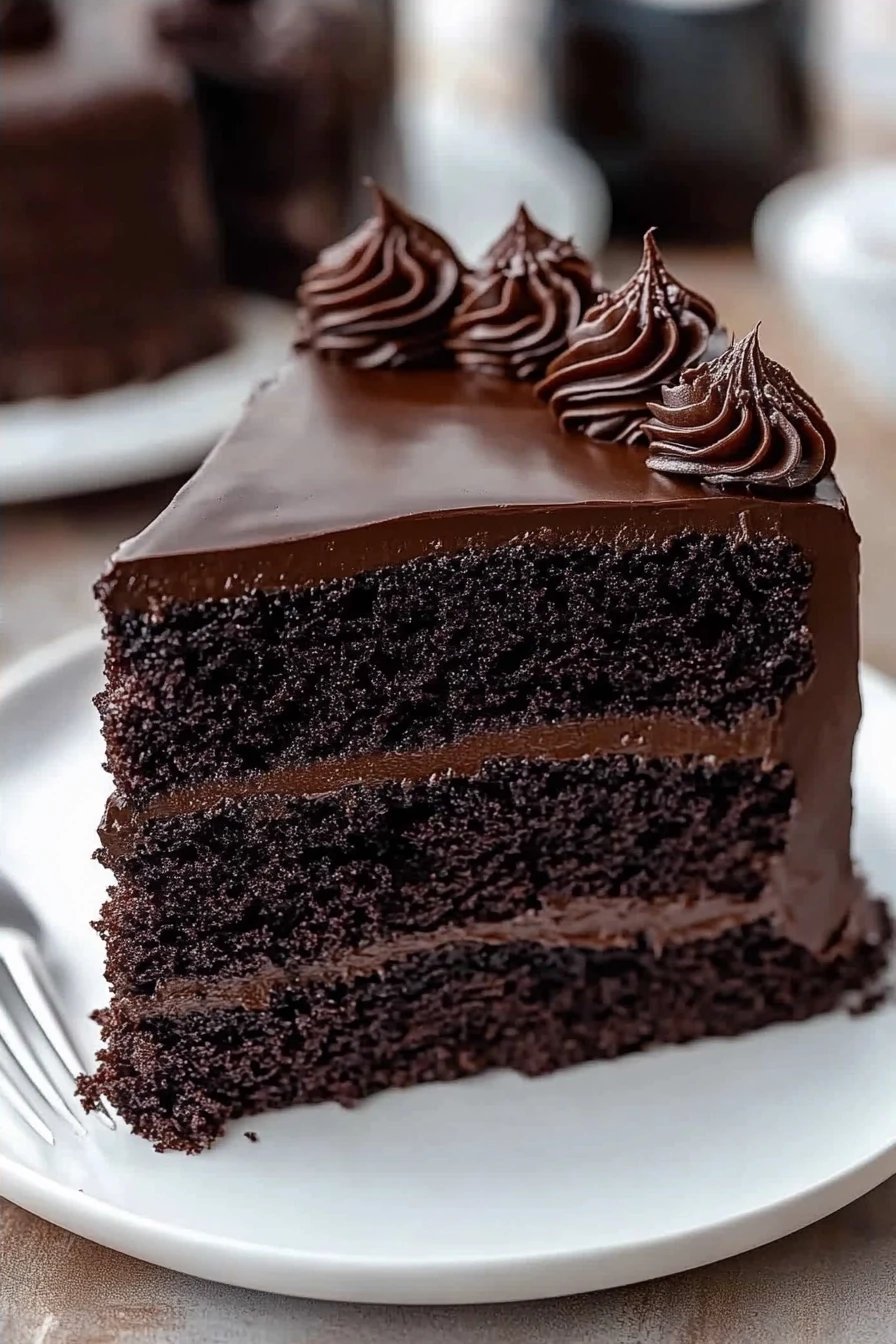 Black Velvet Cake Recipe slice on plate showing perfect texture and swirl pattern