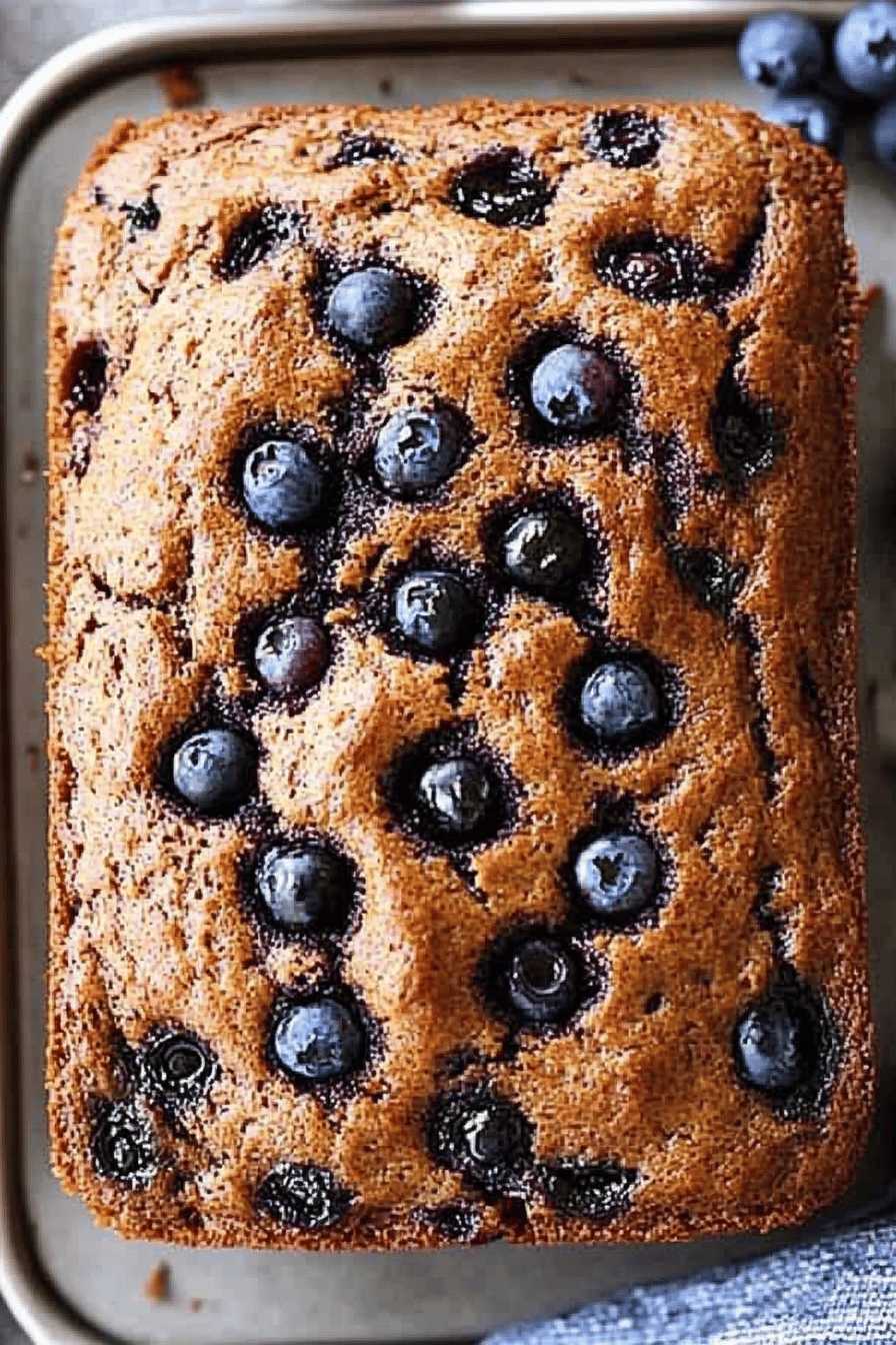 blueberry banana bread slice on plate showing perfect texture and swirl pattern