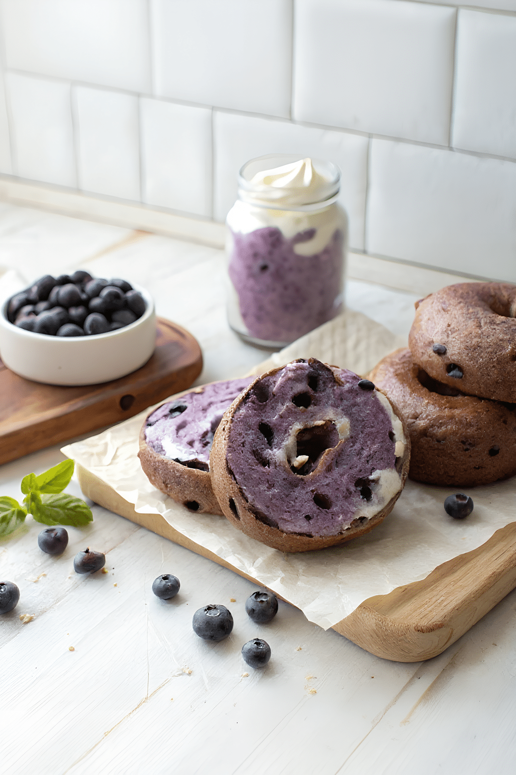 Sliced chocolate chip blueberry bagels showing the creamy center