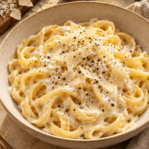 Homemade Alfredo sauce coating pasta